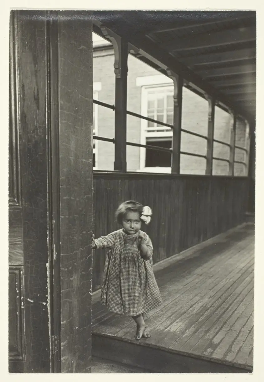 Little Girl Standing At Entrance To A Gallery by Lewis Wickes Hine