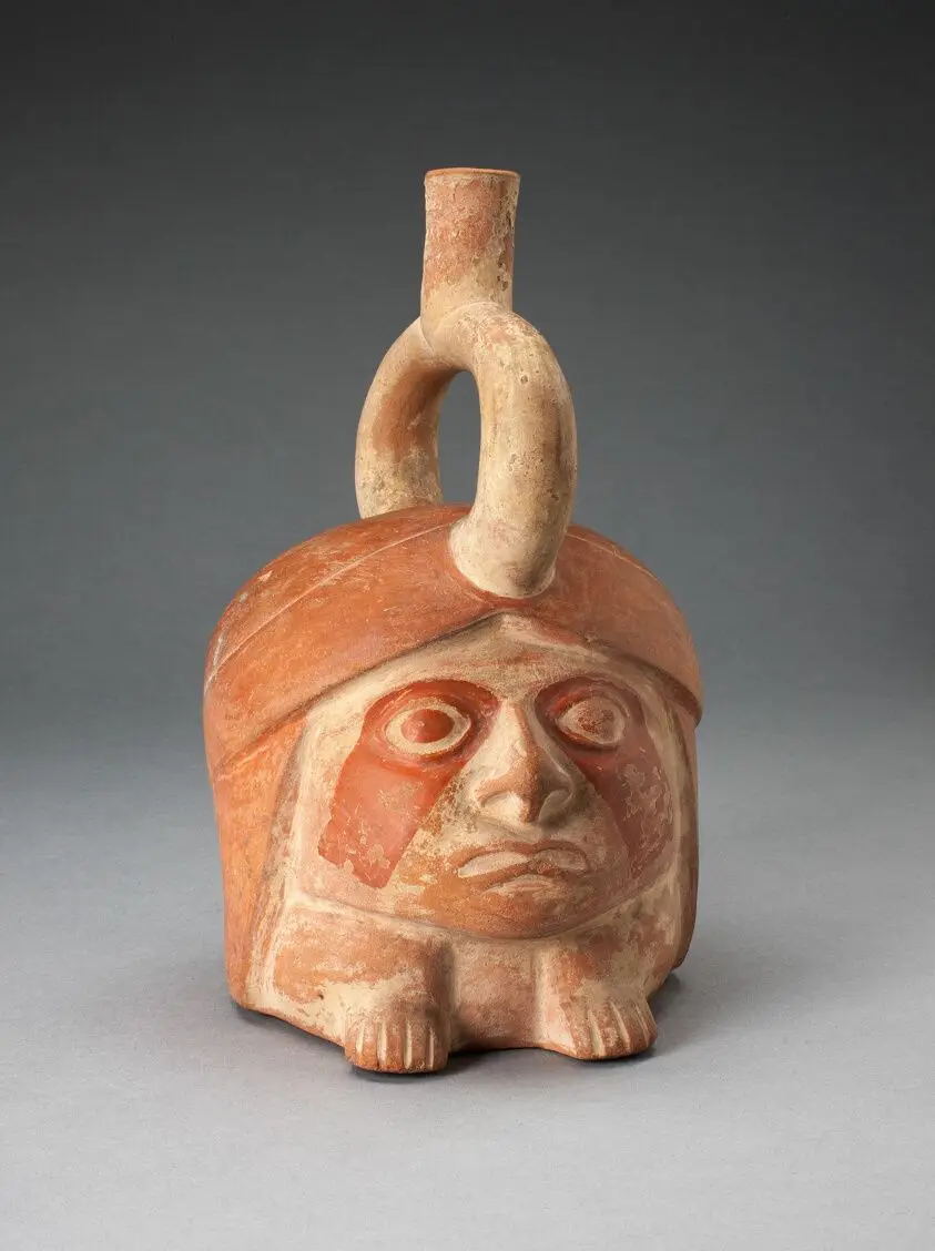 Abstract Portrait Vessel of a Ruler with Painted Face Resting on Feet by Moche