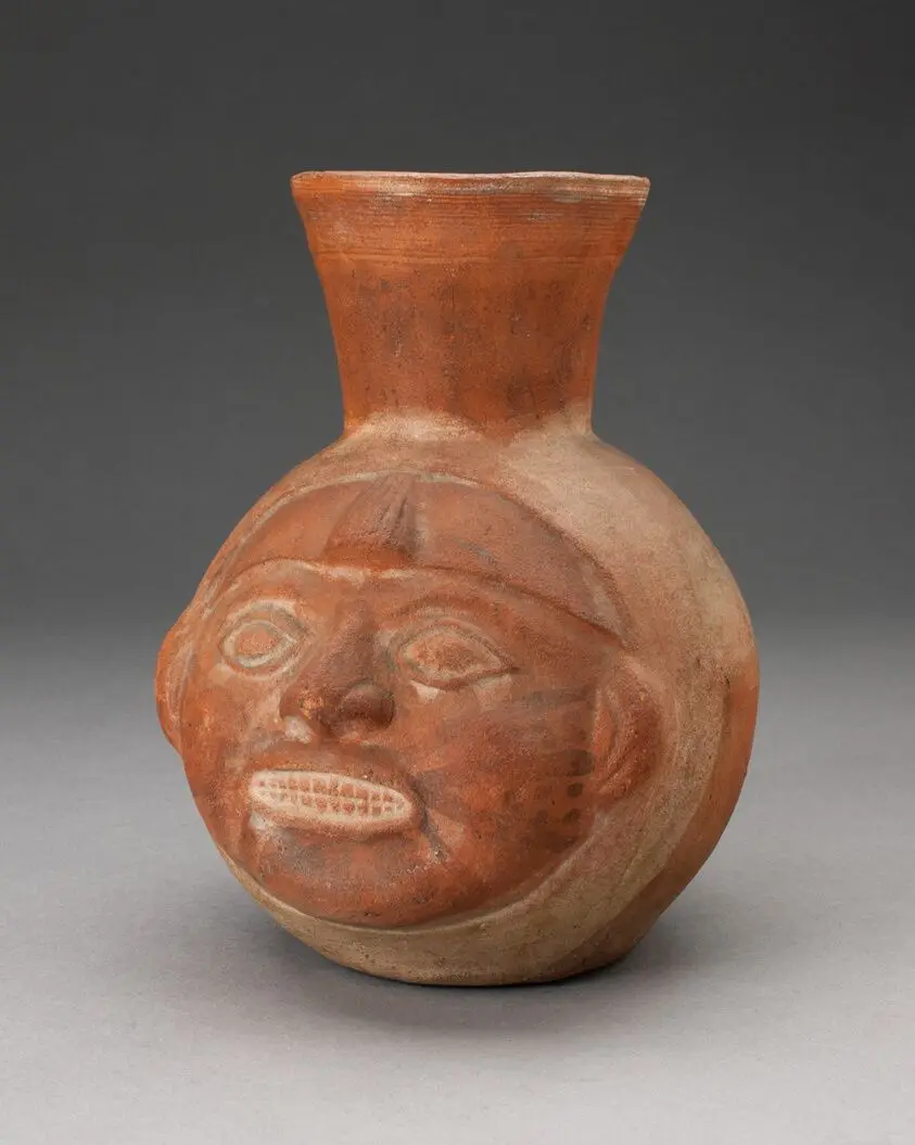 Jar in the Form of a Human Head with Face Painting and Showing Teeth by Moche
