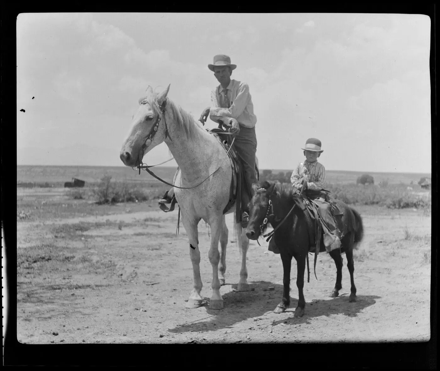 Frank Moson, general manager of the OR, with his four-year-old son "Cowboy Moson," OR Ranch, Arizona by Erwin E. Smith