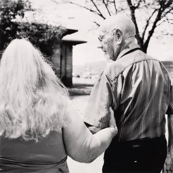 Untitled [man and woman seen from behind; woman clasps man's upper arm] by Sohrab Hura