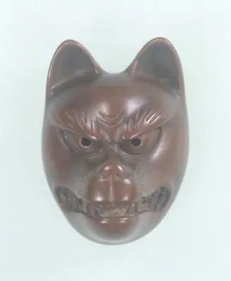 Wood Netsuke., Fox mask. by Unknown artist
