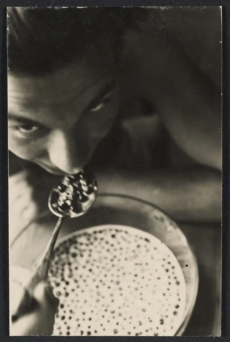 [Person eating blueberries in milk]. by T. Lux Feininger