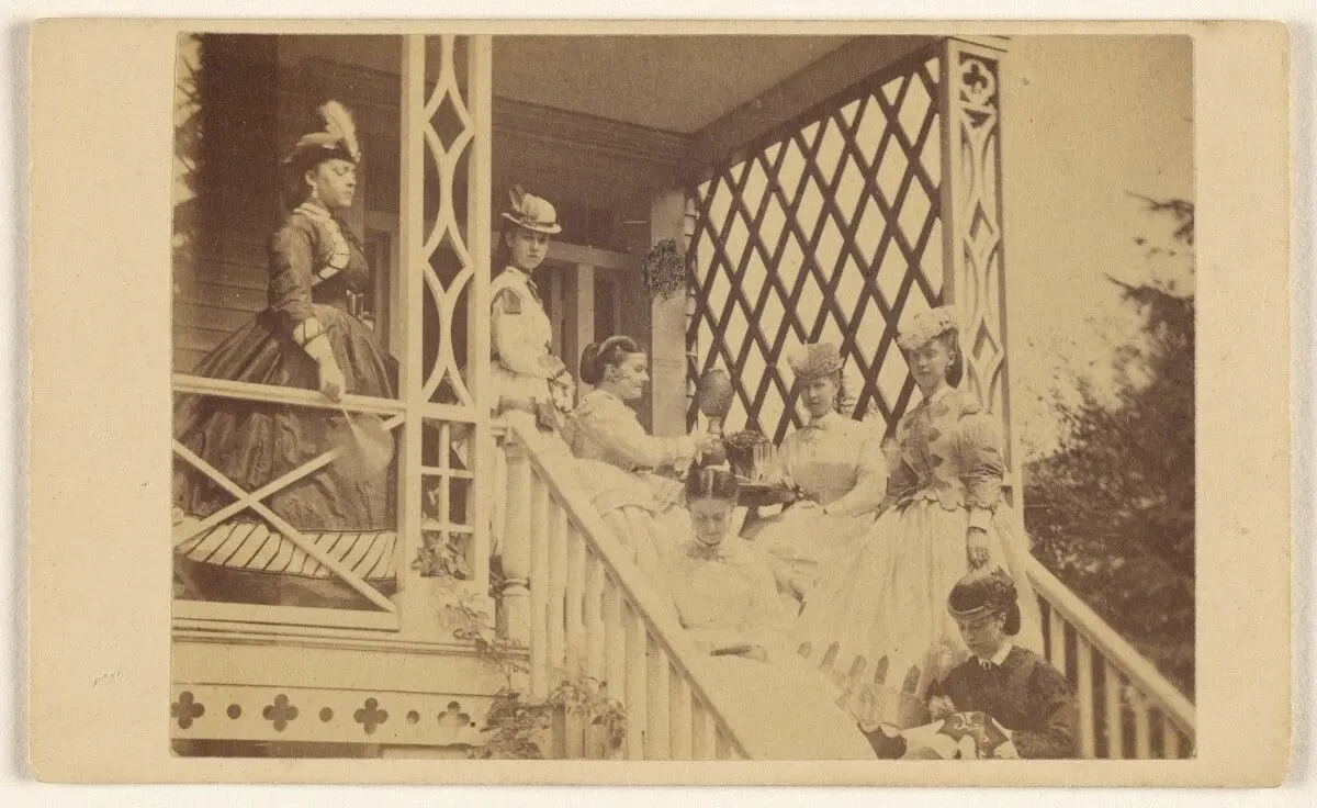 [Seven women either seated or standing on a porch or stairs] by George P. Critcherson