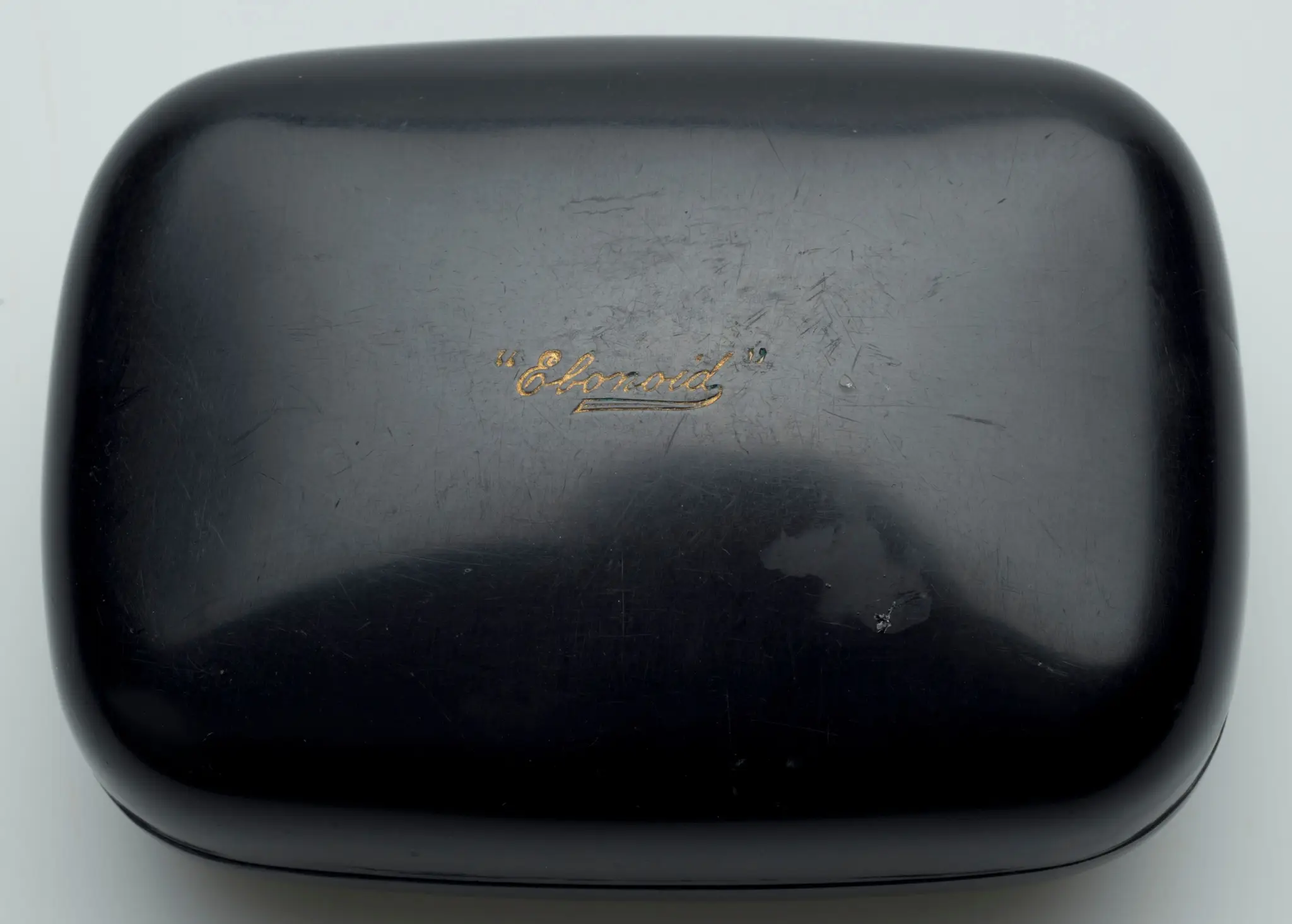 Black soap box with soap residue on interior by American