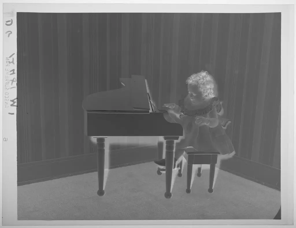 Untitled (little girl playing miniature piano) by Paul Gittings