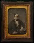 [Unidentified man, half-length portrait, with arm resting on table with tablecloth] by grice, f. (francis)