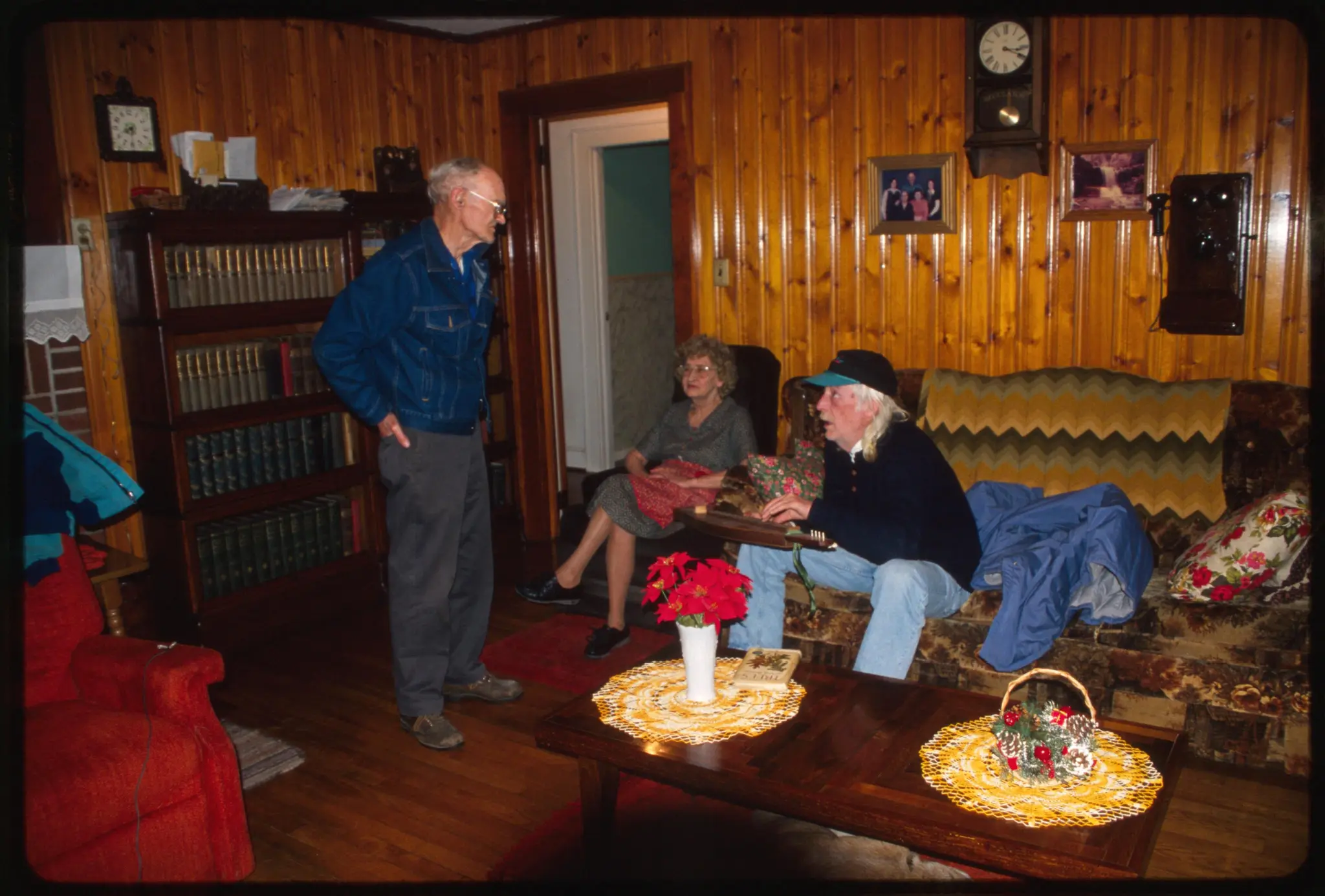 Dennis Dickens (standing) speaking with Ruby Dickens and John Flynn by Dickens, Dennis (Depicted) by Dickens, Dennis (Depicted)