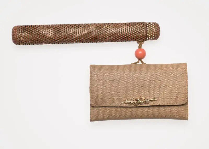 Woven rattan imitating lacquer pipe case, gold fabric tobacco pouch, and coral ojime by Shi 司