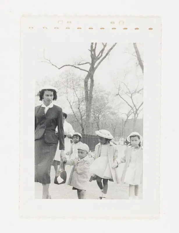 [Woman and children in coats outdoors] by United States