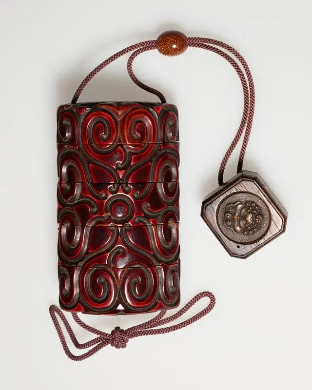 Four-case inro with carved lacquer decoration and netsuke of a box with chinese lion by Japan