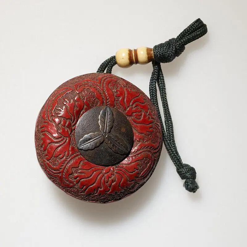 Manju of carved lacquer with floral design by Japan