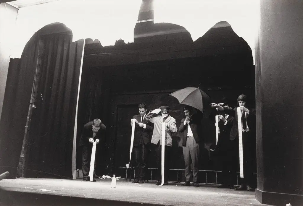 In Memoriam to Adriano Olivetti Version 3 Ballet, performed during Fluxus Festival/Theatre Compositions/Street Compositions/Exhibits/Electronic Music, Hypokriterion Theater, Amsterdam, June 23, 1963 by George Maciunas