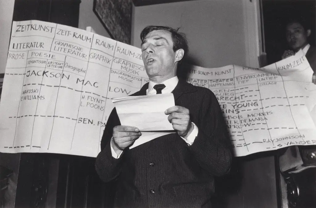 Arthus C. Caspari reading George Maciunas' manifesto Neo-Dada in Music, Theater, Poetry, Art, during Kleines Sommerfest: Après John Cage, Galerie Parnass, Wuppertal, West Germany, June 9, 1962 by Arthus Carlheinz Caspari, George Maciunas, Unidentified photographer
