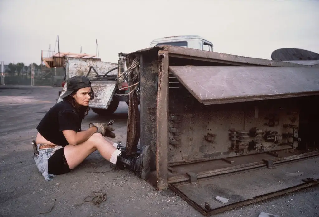 "Pancake," a former shipyard sandblaster, scavenging copper from a waterfront scrapyard. Los Angeles harbor. Terminal Island, California from the series Fish Story by Allan Sekula