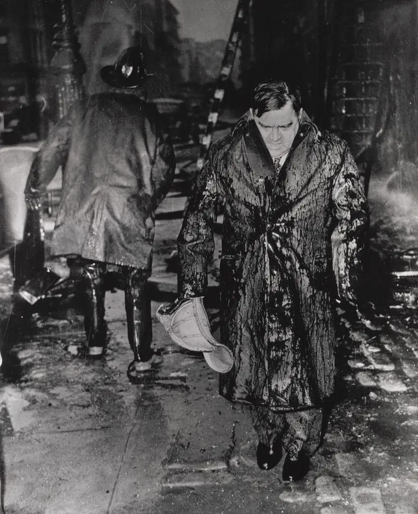 "Leaving a Fire in Drenched Raincoat and Helmet" by Bettmann/United Press International