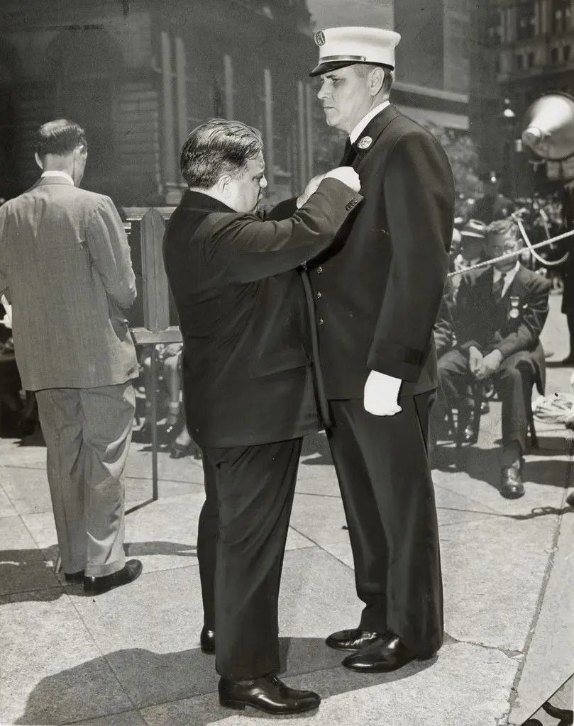 "Fire Captain John W Heany Receiving the James Gordon Benefit and Department Medals from Mayor LaGuardia" by The New York Times