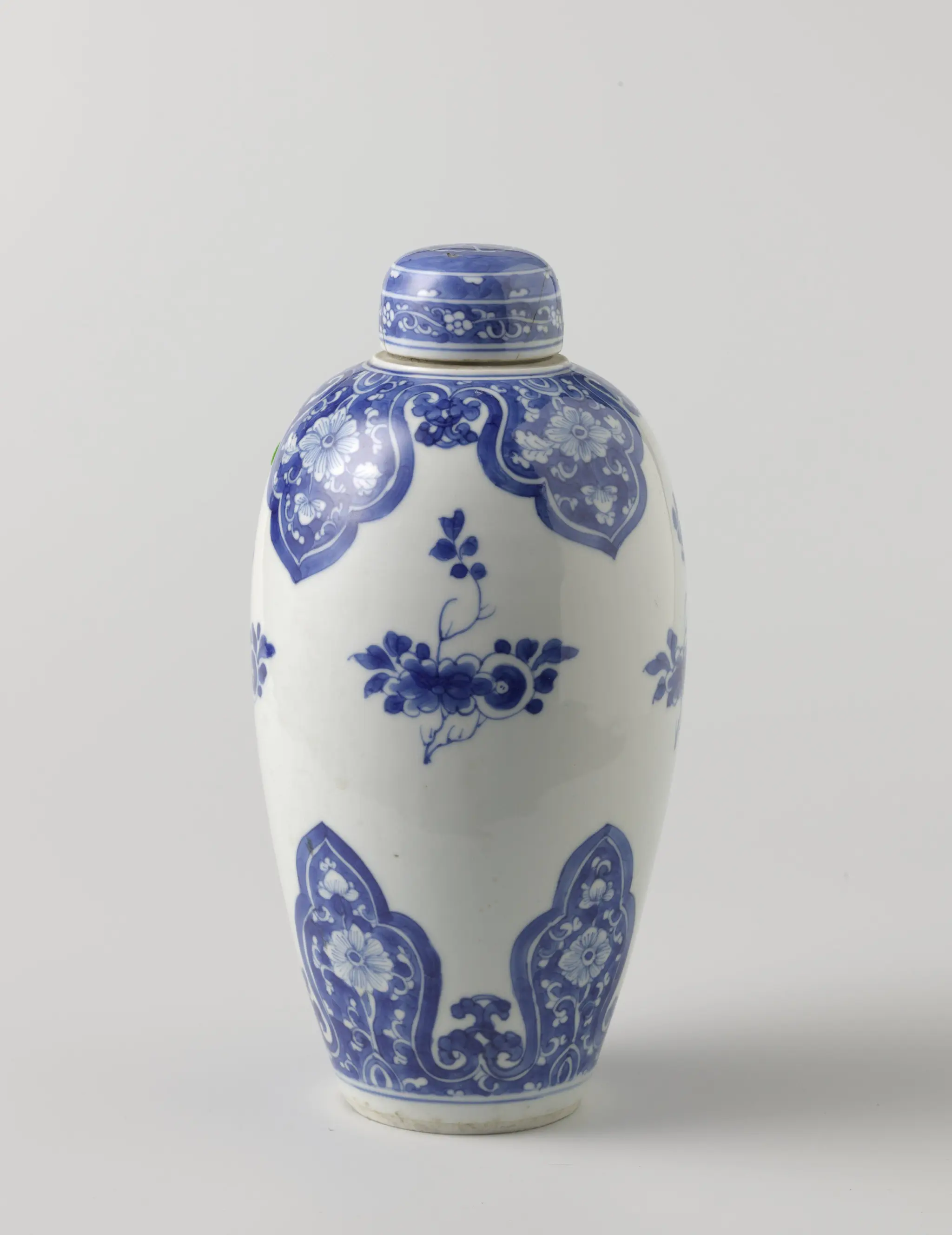 Ovoid covered jar with flower scrolls in lappet borders by anonymous