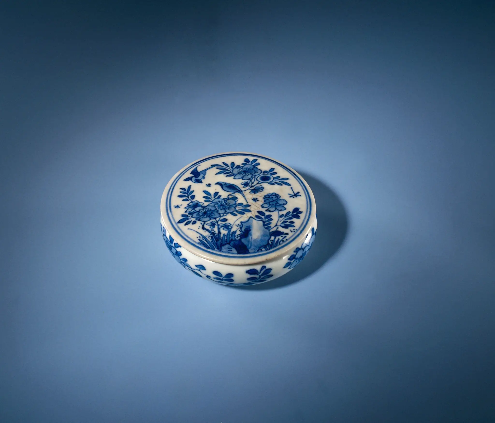 Round box with flowering plans, flower sprays and an erotic scene by anonymous