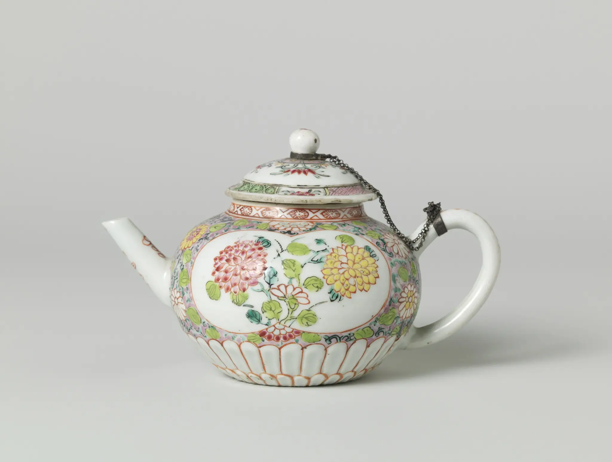 Squat, round-bodied teapot with flower sprays, scrolls and silver mount by anonymous