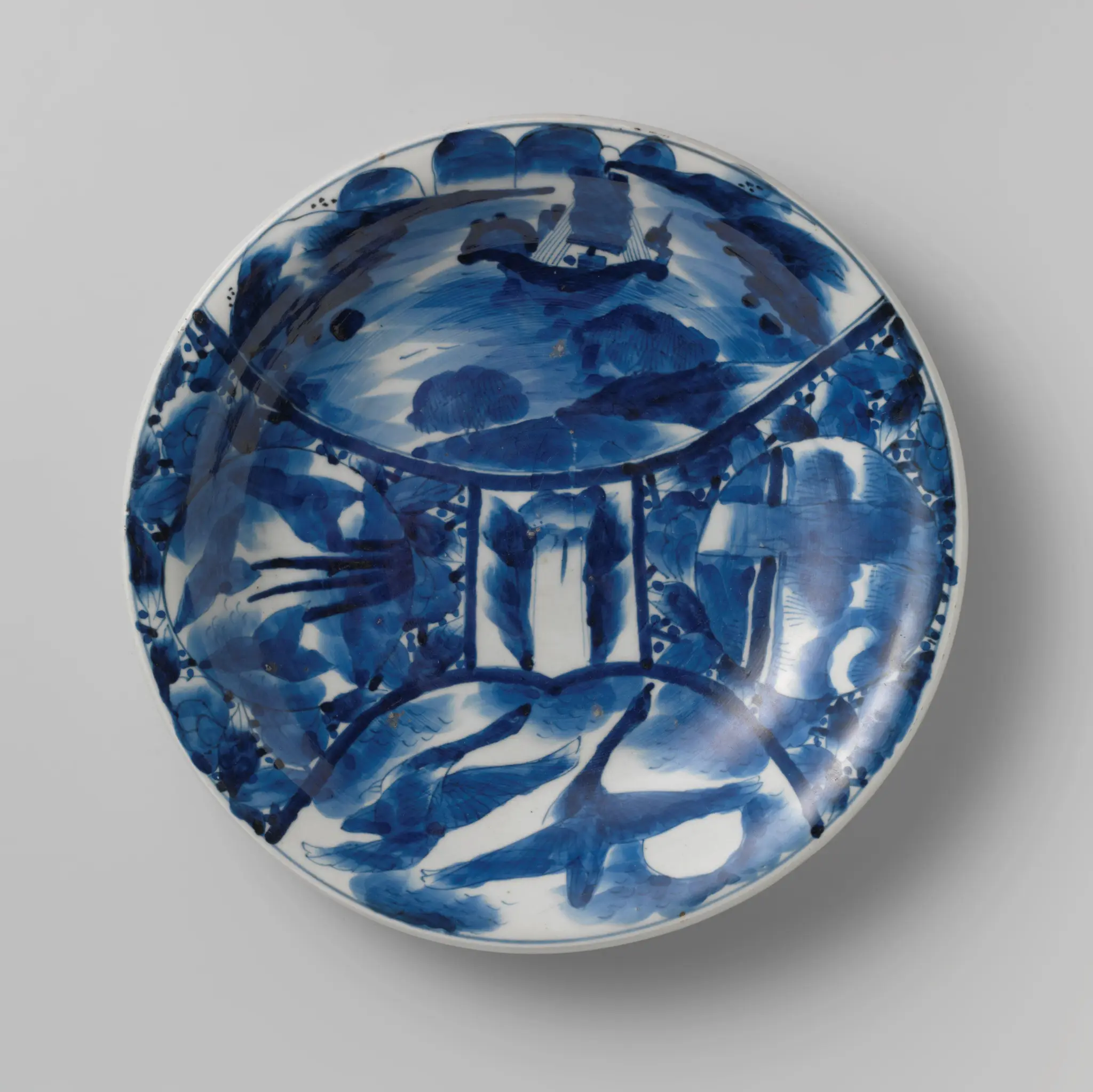 Saucer-dish with a boat, birds and flowering plants in panels by anonymous