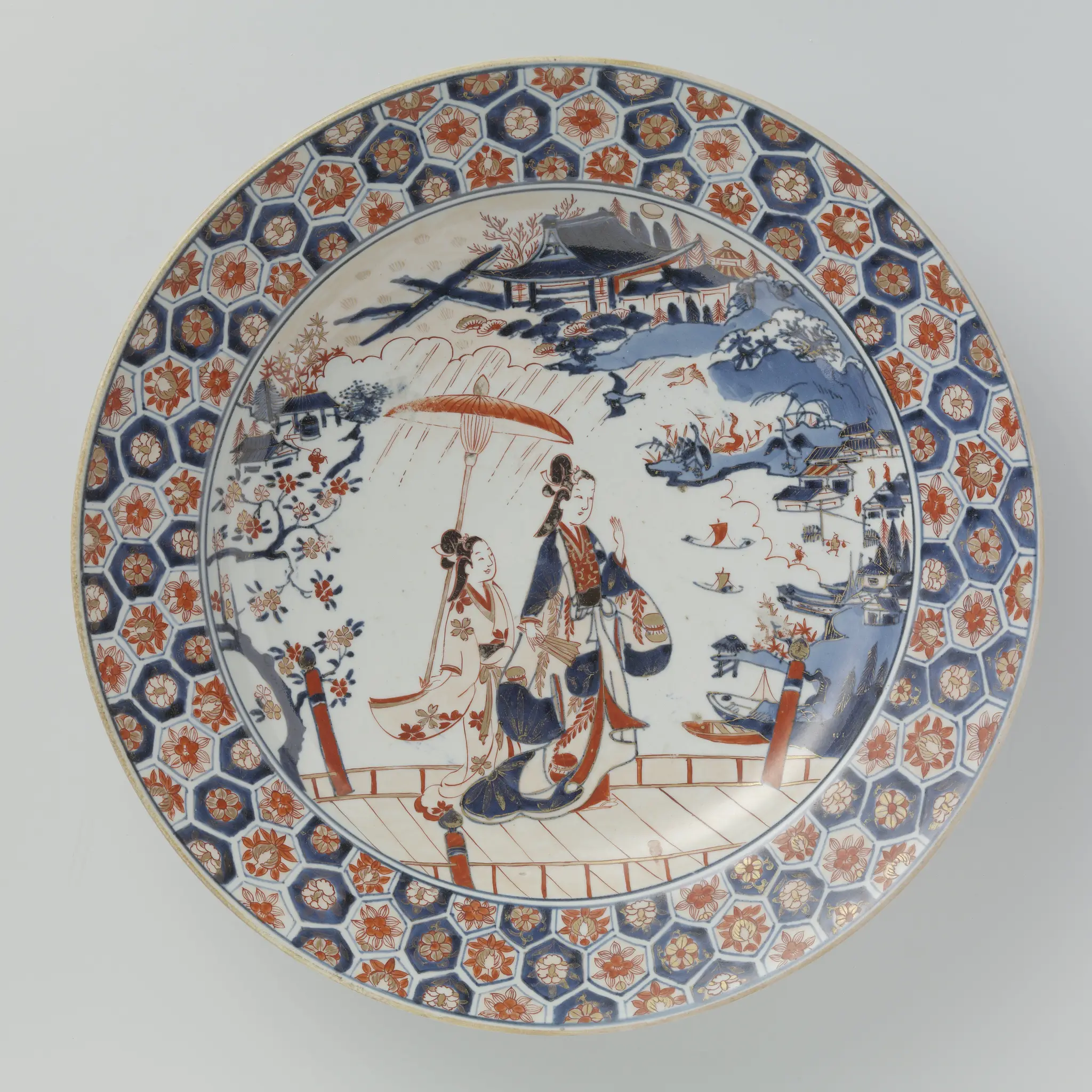 Dish with a woman and attendant on a bridge in a landscape by anonymous
