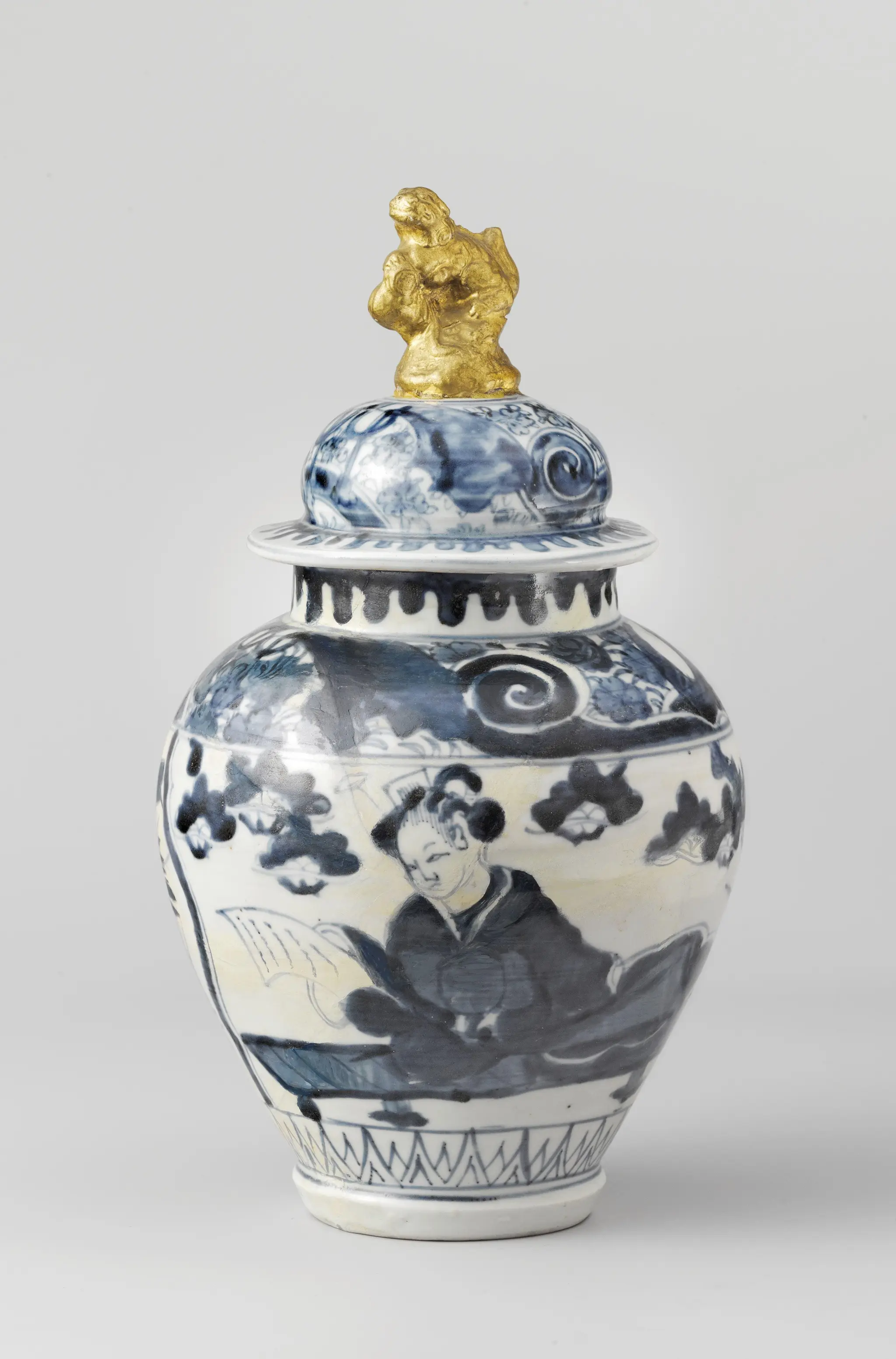 Ovoid covered jar with a woman reading a letter and finial in the shape of a shishi by anonymous