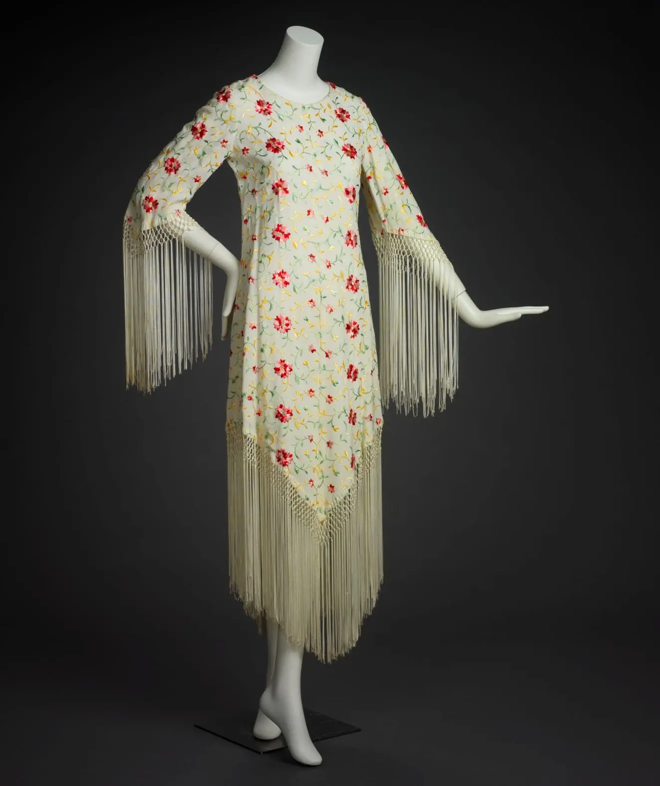 White embroidered floral dress with fringed sleeves by Adolfo Sardina