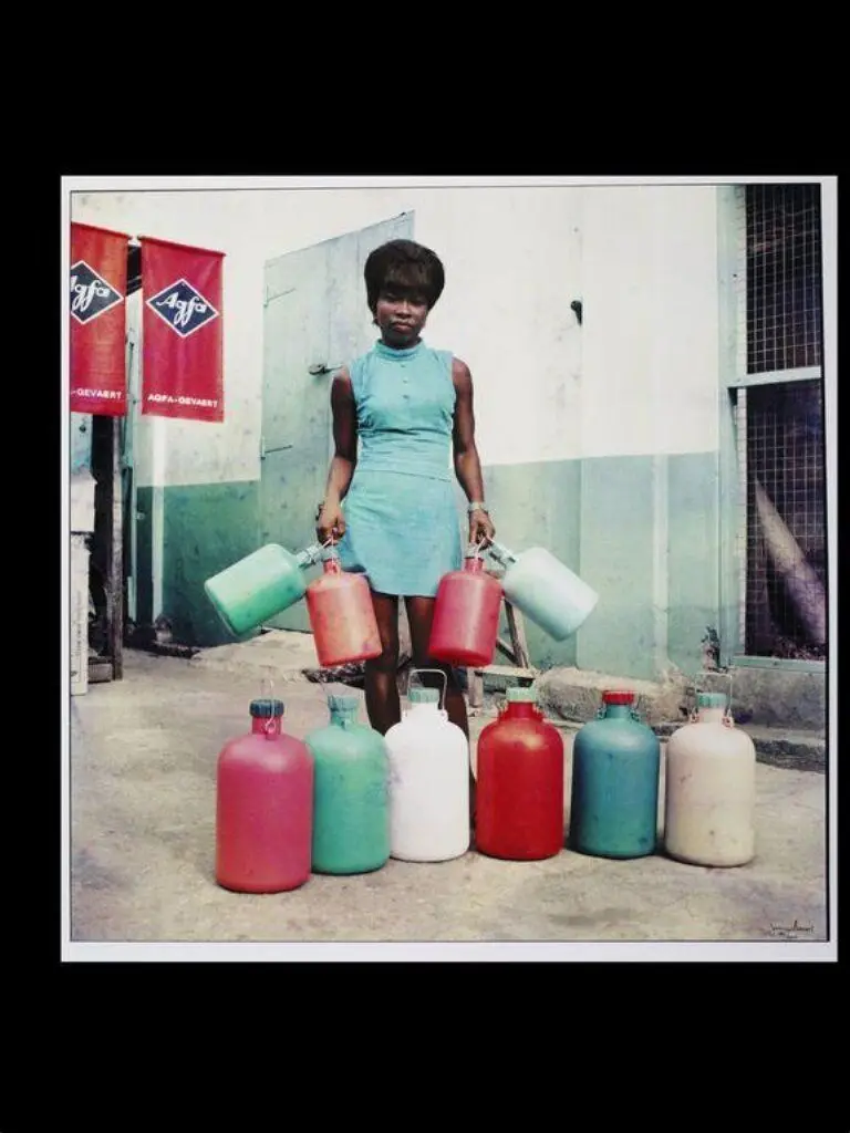Sick-Hagemeyer shop assistant with bottles, taken as a colour guide, Accra by James Barnor
